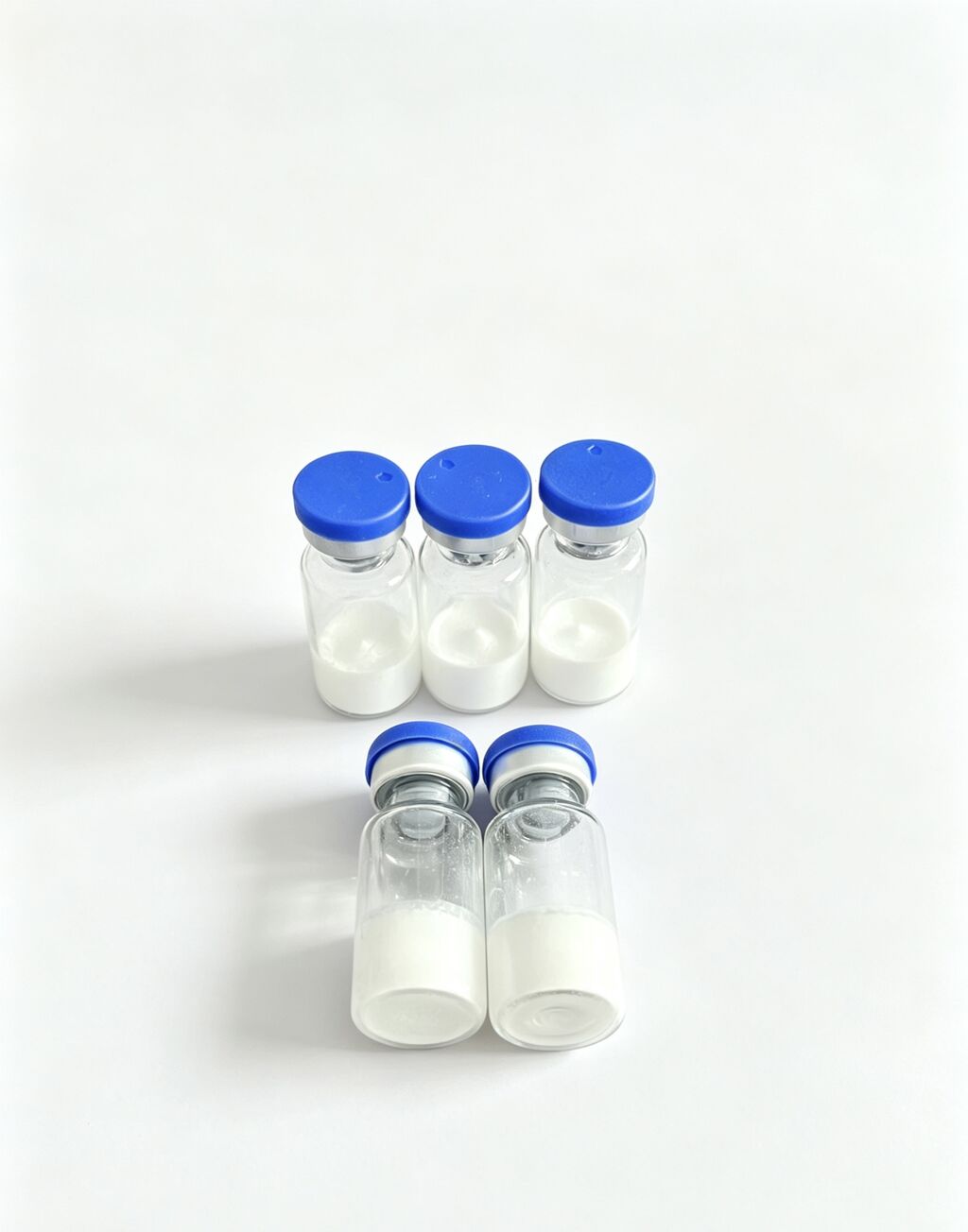 Blue-cap research peptide vials on a neutral background
